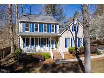 Charming two-story home featuring a welcoming front porch with blue shutters and a well-maintained yard at 2300 Parkside Dr, Durham, NC 27707