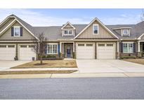 Inviting home featuring a two-car garage, manicured lawn, and a charming facade at 255 Thornwhistle Pl, Garner, NC 27529