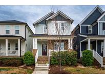 Charming two-story home featuring a welcoming front porch and well-maintained landscaping at 376 Granite Mill Blvd, Chapel Hill, NC 27516