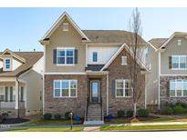 Charming two-story home featuring a stone facade, neutral siding, and a well-manicured lawn at 4117 Bluff Oak Drive Dr, Cary, NC 27519