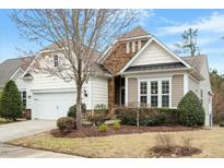 Charming home featuring stone accents, manicured landscaping, and an attached two-car garage at 431 Heralds Way, Cary, NC 27519