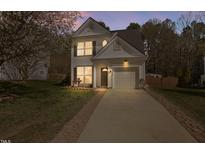 Charming two-story home with manicured lawn and inviting entrance, perfect for suburban living at 5512 Scenic Brook Lane Ln, Raleigh, NC 27616