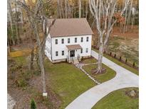 Charming two-story home featuring a manicured lawn, stone walkway and lengthy driveway at 612 Lakeview Dr, Raleigh, NC 27603