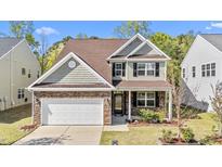 Charming two-story home featuring a stone-accented facade, attached garage, and beautifully landscaped front yard at 69 Florence Dr, Clayton, NC 27527