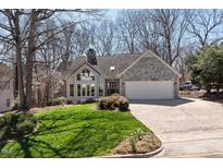 Charming home with stone accents, bright lawn, and an attached two car garage at 8116 Windsor Ridge Dr, Raleigh, NC 27615