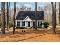 Charming one-story home with black shutters, a wreath, and beautiful landscaping at 918 Circle Dr, Angier, NC 27501