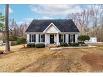 Charming single Gathering home with a well-manicured lawn, black shutters, and a cozy front porch at 918 Circle Dr, Angier, NC 27501