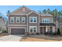 Charming two-story home featuring a well-manicured lawn and an attached two-car garage at 106 Filigree Way, Durham, NC 27713