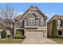 Charming two-story home with a well-maintained lawn and a two-car garage, showcasing inviting curb appeal at 127 Station Dr, Morrisville, NC 27560