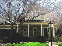 Charming brick home with a covered porch, white columns, and beautifully landscaped front yard at 1818 Buxton Way, Burlington, NC 27215