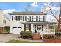 Charming two-story home features a covered front porch, attached garage, and manicured landscaping at 2010 Blanchard St, Apex, NC 27502