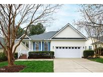 Charming home featuring a two-car garage, manicured lawn, and blue shutters at 2024 Heritage Pines Dr, Cary, NC 27519