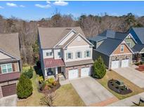 Lovely two-story home featuring manicured lawn, brick accents, two-car garage, and inviting front porch at 205 Virginia Water Dr, Rolesville, NC 27571