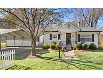 Charming home with black shutters, a covered carport, and a well-maintained lawn at 2246 Arrowhead Rd, Dunn, NC 28334