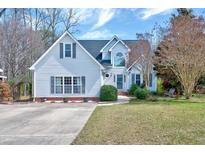 Charming home with blue siding, a manicured lawn, and a welcoming front entrance at 408 Knolls View Dr, Fuquay Varina, NC 27526