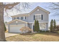 Charming two-story home with a well-manicured lawn and attached two-car garage at 442 Steel Hopper Way, Garner, NC 27529
