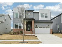Modern two-story home featuring a two-car garage, neutral siding, and brick accents at 4513 Bridle Run Dr, Raleigh, NC 27606