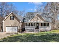 Charming home with a welcoming front porch and attached garage at 484 Galaxy Dr, Garner, NC 27529