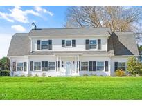 Charming two-story home with black shutters, white siding, and a well-maintained lawn at 518 Parkview Dr, Burlington, NC 27215