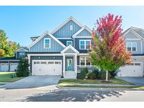 Charming two-story home with a well-manicured lawn, two-car garage, and mature tree at 52 N Rosebank Dr, Chapel Hill, NC 27516