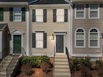 Charming townhome featuring neutral siding, dark shutters, and a welcoming front entrance with steps at 5421 Vista View Ct, Raleigh, NC 27612