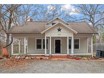 Charming single-story home featuring a cozy front porch and a well-maintained yard at 5505 Farrington Rd, Chapel Hill, NC 27517