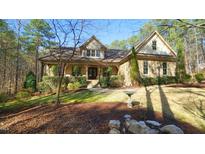 Charming stone and siding home with a covered front porch and landscaped yard surrounded by mature trees at 5640 Bella Terra Ct, Wake Forest, NC 27587