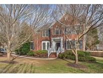 Charming two-story brick home with a manicured lawn and inviting front entrance at 7 Starwood Ln, Durham, NC 27712