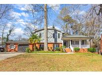 Charming two-story home with brick accents, attached garage, covered porch, and front yard at 817 Roanoke Dr, Cary, NC 27513