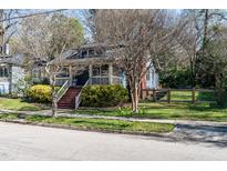 Charming blue home featuring a welcoming front porch and a well-maintained, landscaped yard at 914 Dorothea Dr, Raleigh, NC 27603