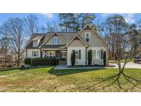 Charming home featuring manicured landscaping, complemented by a well-maintained lawn at 1046 Lawrence Rd, Wake Forest, NC 27587