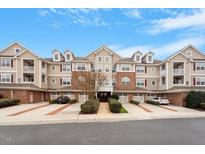 Inviting multi-Gathering exterior with manicured landscaping and private garages offers convenient and stylish living at 10511 Rosegate Ct # 203, Raleigh, NC 27617