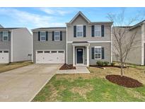 Two-story home featuring gray siding, dark blue shutters, and an attached two-car garage at 1205 Bent Willow Dr, Durham, NC 27704