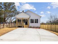 Charming single-story home with a cozy front porch and a well-manicured lawn at 1335 Elrado St, Burlington, NC 27217