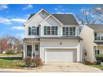 Charming two-story home with a two-car garage, a manicured lawn and green shutters at 1968 Shadow Glen Dr, Raleigh, NC 27604