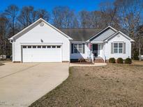 Charming single-story home with a two-car garage and a well-manicured front yard at 203 Patterdale Pl, Benson, NC 27504