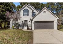 Charming, two-story brick home boasting a beautiful yard and a two-car garage at 2613 Coxindale Dr, Raleigh, NC 27615
