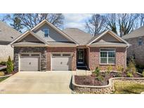 Beautiful brick home featuring an attached two-car garage and manicured landscaping at 310 Macallan, Burlington, NC 27215