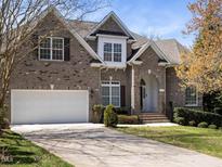 Charming two-story brick home with a well-manicured lawn and attached two-car garage at 314 Montelena Pl, Cary, NC 27513