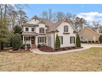 Charming two-story brick home with a well-manicured lawn and inviting curb appeal at 3421 Griffice Mill Rd, Raleigh, NC 27610