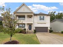 Charming two-story home with a covered front porch and well-maintained landscaping at 421 Pine Burr St, Fuquay Varina, NC 27526