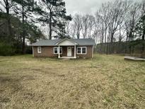 Charming single-story brick home with a well-maintained yard surrounded by mature trees at 4989 Nc 217, Erwin, NC 28339