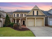 Inviting two-story home featuring a two-car garage, manicured lawn, and classic architectural design at 5102 Highcroft Dr, Cary, NC 27519