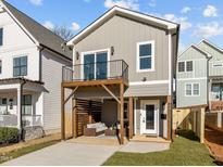 Charming two-story home with a balcony above a cozy outdoor seating area and well-manicured lawn at 517 Coleman St, Raleigh, NC 27610