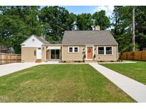 Charming single-Gathering home with a well-maintained front yard and inviting, bright colored front door at 518 W Chisholm St, Sanford, NC 27330
