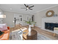 Bright living room features hardwood floors, fireplace, and neutral paint scheme at 518 W Chisholm St, Sanford, NC 27330