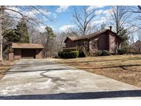 Charming home with a long driveway, mature trees and separate garage in a secluded location at 5315 Cole Mill Rd, Durham, NC 27705