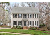 Charming two-story home featuring a well-maintained lawn and symmetrical facade at 6004 Bramblewood Dr, Raleigh, NC 27612