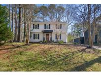 Traditional two-story home with white siding, dark shutters, and a well-maintained front lawn at 7216 Bluffside Ct, Raleigh, NC 27615