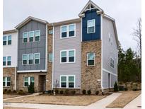 Modern townhome featuring a brick and gray siding exterior at 730 Firebrick Drive Dr, Cary, NC 27519